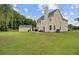 Spacious backyard with a well-manicured lawn, patio seating, and mature trees at 249 Old Savannah Dr, Goose Creek, SC 29445