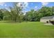 Expansive backyard featuring a serene pond, mature trees, and a lush lawn at 249 Old Savannah Dr, Goose Creek, SC 29445