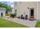 Inviting backyard patio with two Adirondack chairs perfect for outdoor relaxation and enjoying the lush greenery at 249 Old Savannah Dr, Goose Creek, SC 29445