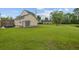 Spacious backyard with lush lawn, mature trees, and a serene pond, offering plenty of room for outdoor enjoyment at 249 Old Savannah Dr, Goose Creek, SC 29445