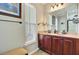 A bathroom has a double sink vanity, a mirror, and a window at 249 Old Savannah Dr, Goose Creek, SC 29445