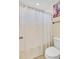 Compact bathroom with white fixtures and a striped shower curtain for a clean, modern look at 249 Old Savannah Dr, Goose Creek, SC 29445