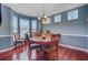Elegant dining room featuring dark wood floors, a stylish table, and bright natural lighting at 249 Old Savannah Dr, Goose Creek, SC 29445