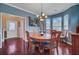 Elegant dining room featuring dark wood floors, a stylish table, and bright natural lighting at 249 Old Savannah Dr, Goose Creek, SC 29445