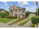 Charming two-story home with a detached garage, red shutters, and a manicured front yard at 249 Old Savannah Dr, Goose Creek, SC 29445