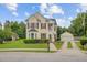 Charming two-story home with a detached garage, red shutters, and a manicured front yard at 249 Old Savannah Dr, Goose Creek, SC 29445