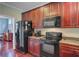 An updated kitchen has dark appliances, granite countertops, and dark wood cabinets at 249 Old Savannah Dr, Goose Creek, SC 29445