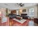 Open-concept living room with plush seating, a fireplace, and dark wood floors at 249 Old Savannah Dr, Goose Creek, SC 29445