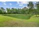 Scenic view of a lush pond surrounded by mature trees and greenery, creating a serene natural setting at 249 Old Savannah Dr, Goose Creek, SC 29445