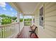 Inviting porch with wood floors, white railings, and a comfortable bench for enjoying the outdoor views at 249 Old Savannah Dr, Goose Creek, SC 29445