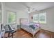Comfortable bedroom with hardwood floors, ceiling fan, and ample natural light from two windows at 2736 Shadow Ln, North Charleston, SC 29406