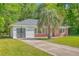 Cozy home featuring brick accents, white siding, and a well-manicured lawn at 2736 Shadow Ln, North Charleston, SC 29406