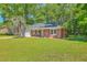 Charming single-story home with a well-maintained lawn and a mature palm tree at 2736 Shadow Ln, North Charleston, SC 29406