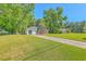 Quaint brick home with a spacious front yard and mature trees providing ample shade at 2736 Shadow Ln, North Charleston, SC 29406