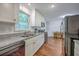 Bright kitchen with stainless steel appliances, granite countertops, and an adjacent dining area at 2736 Shadow Ln, North Charleston, SC 29406