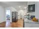 The kitchen features stainless appliances, granite countertops, and flows into an adjacent room at 2736 Shadow Ln, North Charleston, SC 29406