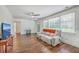 Open living room with hardwood floors, an inviting couch, and a large window for natural light at 2736 Shadow Ln, North Charleston, SC 29406