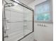 Bright shower featuring a modern showerhead, glass doors, and chrome hardware at 2736 Shadow Ln, North Charleston, SC 29406