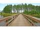 Scenic view of a wooden bridge crossing a serene lake surrounded by lush green trees at 291 Calm Water Way, Summerville, SC 29486