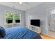 Bright bedroom with TV, window view, and ensuite bathroom entrance at 2948 Treadwell Street St, Mount Pleasant, SC 29466
