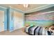 Unique bedroom with a baseball stadium mural, ceiling fan, and comfortable bed at 302 Axeminster Ct, Goose Creek, SC 29445