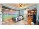Fun bedroom with a baseball stadium mural, ceiling fan, and built-in shelves at 302 Axeminster Ct, Goose Creek, SC 29445