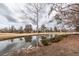 Backyard view of the community golf course and a pond with a golf cart in the background at 305 Flowering Peach Ct # 202, Charleston, SC 29414