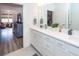 Bright bathroom features double vanity, and open view into adjacent living room at 305 Flowering Peach Ct # 202, Charleston, SC 29414