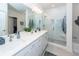 Bright bathroom features double vanity, glass enclosed shower, and soaking tub with tiled surround at 305 Flowering Peach Ct # 202, Charleston, SC 29414
