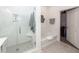 Bright bathroom features walk in shower with tiled surround, soaking tub, and open walk in closet at 305 Flowering Peach Ct # 202, Charleston, SC 29414