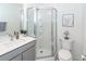Bathroom with modern shower, white vanity, decorative art, and mosaic tile floor at 305 Flowering Peach Ct # 202, Charleston, SC 29414