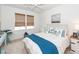 Bedroom features white bedding, blue accents, natural light, and ceiling fan at 305 Flowering Peach Ct # 202, Charleston, SC 29414