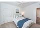 Bedroom features white bedding, blue accents, natural light, and ceiling fan at 305 Flowering Peach Ct # 202, Charleston, SC 29414
