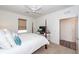 Bedroom features white bedding, natural light, and adjacent doorway at 305 Flowering Peach Ct # 202, Charleston, SC 29414