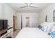 Bright bedroom features a ceiling fan, ensuite bathroom, and white coastal decor at 305 Flowering Peach Ct # 202, Charleston, SC 29414