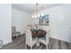 Well-lit dining room features modern lighting and a round wooden table with seating at 305 Flowering Peach Ct # 202, Charleston, SC 29414