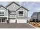 Gray two-story townhome with white trim, a two-car garage, and a covered balcony at 305 Flowering Peach Ct # 202, Charleston, SC 29414