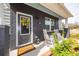 Inviting front porch with rocking chairs, stylish decor and a 'Welcome Home' doormat at 305 Flowering Peach Ct # 202, Charleston, SC 29414