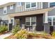 Charming front porch with rocking chairs, black brick, and manicured landscaping at 305 Flowering Peach Ct # 202, Charleston, SC 29414