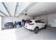 Spacious garage features a white car, white door, painted white walls, and a clean garage floor at 305 Flowering Peach Ct # 202, Charleston, SC 29414