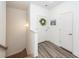 Bright hallway with decorative wreath, coastal artwork and stylish flooring, well-lit by a sconce at 305 Flowering Peach Ct # 202, Charleston, SC 29414