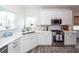 Bright kitchen with stainless steel appliances, white cabinets, and stylish backsplash at 305 Flowering Peach Ct # 202, Charleston, SC 29414