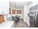 Bright kitchen features stainless steel appliances, white cabinetry, and breakfast nook at 305 Flowering Peach Ct # 202, Charleston, SC 29414