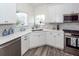 Bright kitchen featuring white cabinetry, modern appliances, quartz countertops, and stylish backsplash at 305 Flowering Peach Ct # 202, Charleston, SC 29414