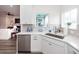 Modern kitchen features quartz countertops, white cabinetry, and stainless-steel appliances at 305 Flowering Peach Ct # 202, Charleston, SC 29414