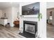 Cozy living room features fireplace with mounted television and decorative furnishings at 305 Flowering Peach Ct # 202, Charleston, SC 29414