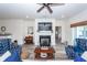 Bright living room with a fireplace, flat-screen TV, and comfortable seating at 305 Flowering Peach Ct # 202, Charleston, SC 29414