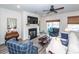 Comfortable living room featuring a fireplace, ceiling fan, and sliding glass doors at 305 Flowering Peach Ct # 202, Charleston, SC 29414