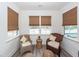 Cozy sunroom with comfortable wicker chairs and natural light at 305 Flowering Peach Ct # 202, Charleston, SC 29414