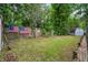 Fenced backyard with a lawn, storage shed, and mature trees at 313 Houston Dr, Ladson, SC 29456